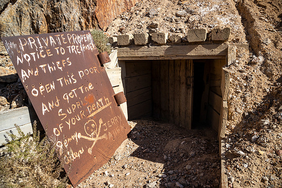 Historic Warning Sign Painted on the Door of an Abandoned Mine - Nevada. Eric Thome, 2024